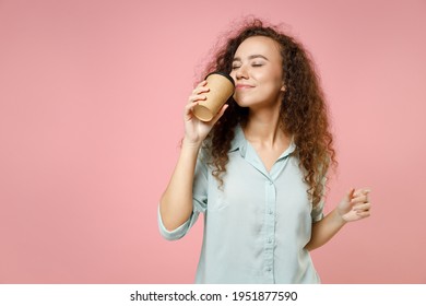 Young Black African American Smiling Happy Curly Woman 20s Wearing Casual Blue Shirt Drinking Hot Tea Holding Paper Cup Of Coffee Smells Scent Isolated On Pastel Pink Color Background Studio Portrait