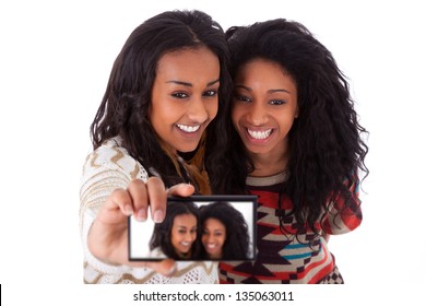 Young black african american teenage girls taking pictures with cell phone, isolated on white background - african people - Powered by Shutterstock