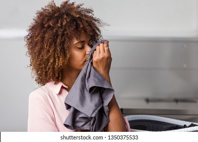 Young Black African American Woman Washing Her Clothes In A Automatic Laundry