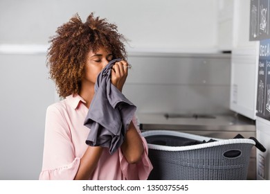 Young Black African American Woman Washing Her Clothes In A Automatic Laundry