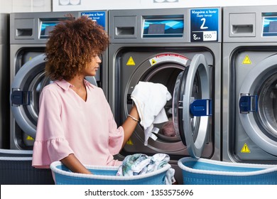 Young Black African American Woman Washing Her Clothes In A Automatic Laundry - Translated Text : Washing Machine Super Wringing