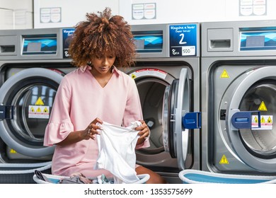 Young Black African American Woman Washing Her Clothes In A Automatic Laundry - Translated Text : Washing Machine Super Wringing