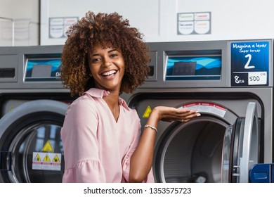 Young Black African American Woman Washing Her Clothes In A Automatic Laundry - Translated Text : Washing Machine Super Wringing