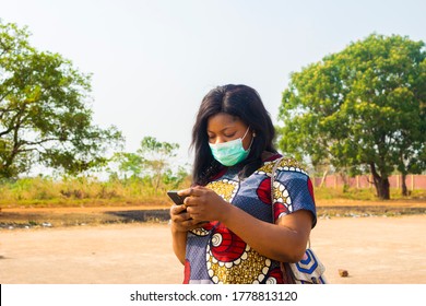 Young Black African Female Business Woman Wearing Face Mask Checking Internet. Black African University Student Wearing Nose Mask Chatting With Friends On Social Media.outdoor Concept