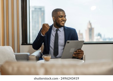 Young black african man relaxing using tablet computer working and startup idea at office.Young creative african man working and typing  smart online at company - Powered by Shutterstock