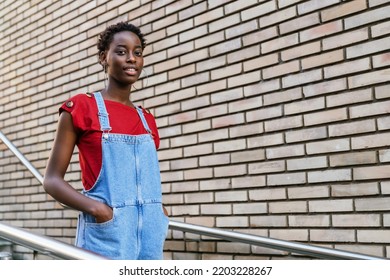 Young Black African Model Woman Walking Down The Stairs Of Her House Doorway Going Out To The Street.