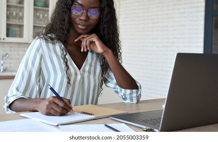 Young Black African Woman Student Learning Online Using Laptop Computer, Taking Notes, Watching Webinar Or Virtual Education Remote E Class Studying At Home. Distance Education Concept.