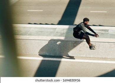 Young Black Athlete Doing Jumping Exercise After Warming Up Outdoors