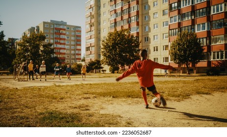 Young Black Boy Playing Soccer with Diverse Friends. Multiethnic Kids Enjoying a Game of Football in the Neighborhood. Player Celebrating the Goal with Teammates. - Powered by Shutterstock