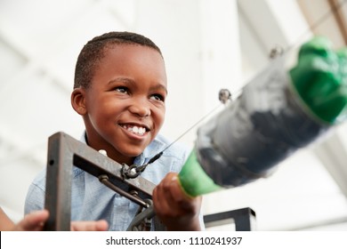 Young Black Boy Using Air Pressure Rocket At Science Centre