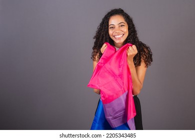 Young Black Brazilian Woman Holding Bisexual Flag And Smiling Looking At Camera, Bisexual Woman, LGBT, LGBTQ