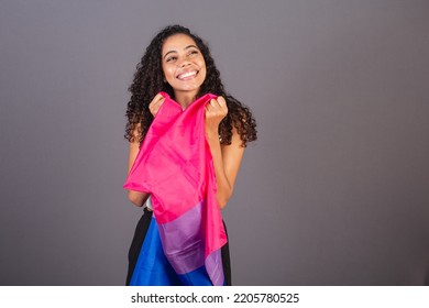 Young Black Brazilian Woman Holding Bisexual Flag And Smiling Looking At Camera, Bisexual Woman, LGBT, LGBTQ