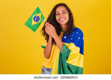 Young black Brazilian woman, soccer fan. waving flag, patriotic, nationalist.