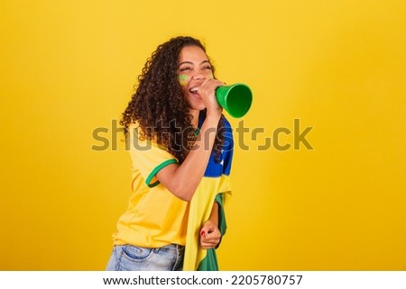 Young black Brazilian woman, soccer fan. screaming through loudspeaker. advertising photo.