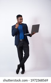 young black business man holding a laptop feeling excited and happy, rejoicing about something