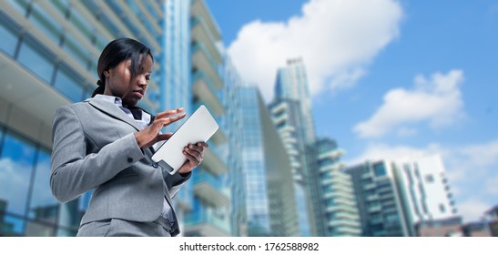 Young Black Business Woman Using A Tablet In Front Of Her Office