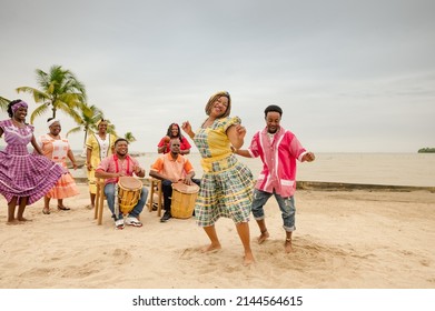 Young black couple dancing at a Caribbean beach party. - Shutterstock ID 2144564615