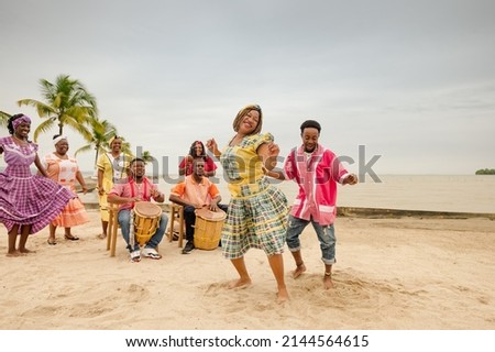Young black couple dancing at a Caribbean beach party.