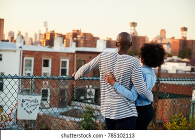 Young Black Couple Embracing On Brooklyn Rooftop, Back View