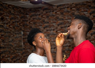 Young Black Couple Enjoy Eating Chips Together