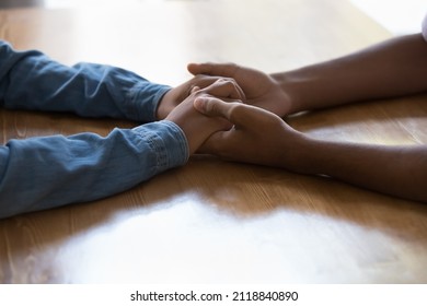 Young Black Couple Holding Arms Over Table, Having Difficult Conversation. Man Touching Hands Of Dark Skinned Girlfriend, Giving Care, Love, Support, Compassion, Empathy. Close Up, Cropped Shot