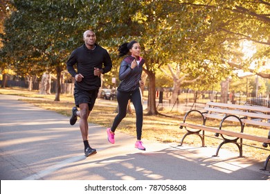 Young black couple jogging in a Brooklyn park - Shutterstock ID 787058608