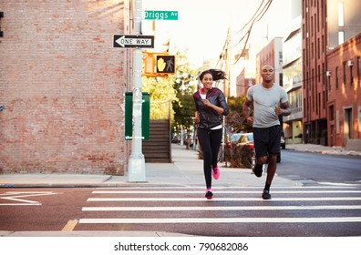 Young Black Couple Jogging In Brooklyn Street