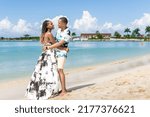 Young black couple look into each others eyes on the beach. Jamaican couple