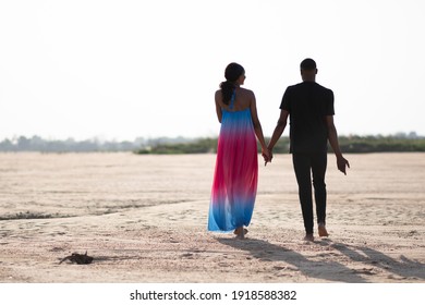 Young Black Couple Walking On A Beach