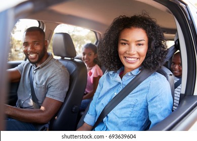 Young Black Family In A Car On A Road Trip Smiling To Camera