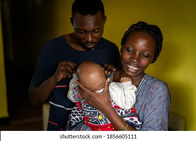 Young Black Family Happy Mom And Dad Holding Baby