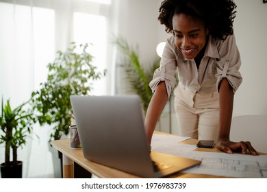 The Young Black Female Architect Working On Project, With Smile And Happy Face.