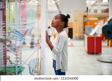 Young Black Girl Looking At A Science Exhibit, Close Up