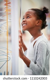 Young Black Girl Looking At A Science Exhibit, Vertical