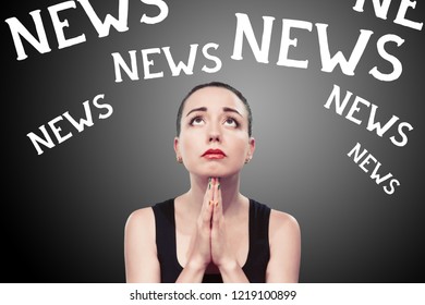 Young Black Haired Woman Holding Praying Hands And Looking Up As Begging For Good News And Multiple Word News Above Her Head, Front View Studio Shot Against Black Background