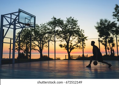 young black handsome man playing basketball on sunrise, morning sports, healthy lifestyle, having fun,  - Powered by Shutterstock