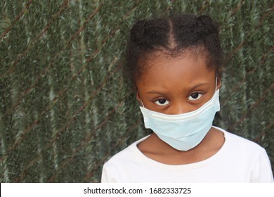 Young Black Kid Wearing Surgical Mask With Green Background