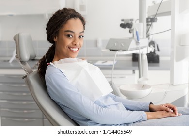 Young Black Lady Sitting In Dentist Chair And Smiling At Camera, Copy Space