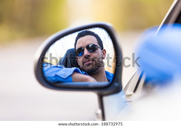 Young
black latin american driver  driving his new
car