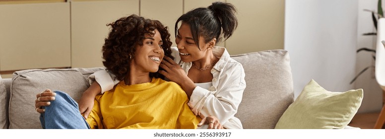 A young Black lesbian couple relaxes together in their chic home, enjoying each others company, banner - Powered by Shutterstock