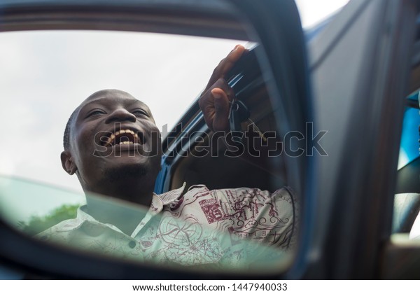 young black male\
driver laughing at\
something