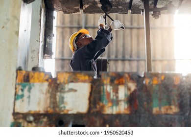 Young Black Male Engineer

Checking Checking And Repair The Machine In Heavy Industry Manufacturing Facility. Service And Maintenance Of Factory Machinery. American African People.