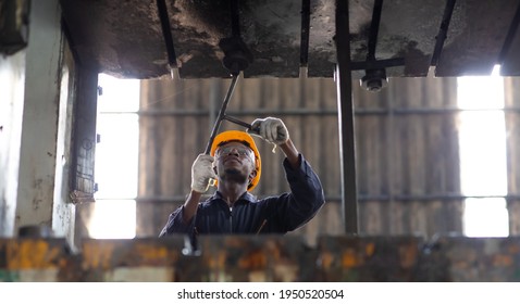 Young Black Male Engineer

Checking Checking And Repair The Machine In Heavy Industry Manufacturing Facility. Service And Maintenance Of Factory Machinery. American African People.