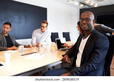 Young Black Male Executive Smiling And Facing Camera During Work Meeting