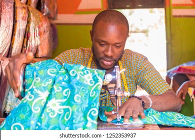 young black male tailor working with his sewing machine  - Shutterstock ID 1252353937