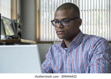 Young Black Male Working On A Computer In An Office Setting
