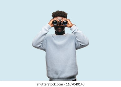 Young Black Man With Binoculars Looking Far