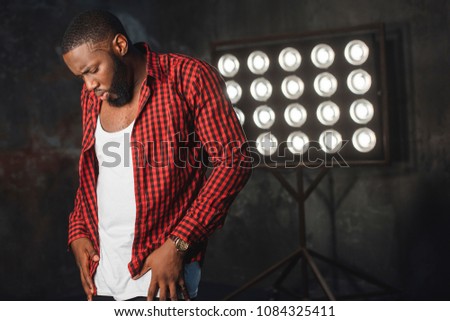 A young black man dancer, posing while performing his choreography