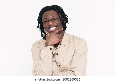 Young black man with dreadlocks laughing and looking at camera isolated over white background