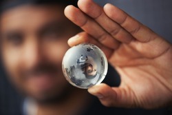 Young Black Man Holding A Glass Gloe Sphere In Hand. 